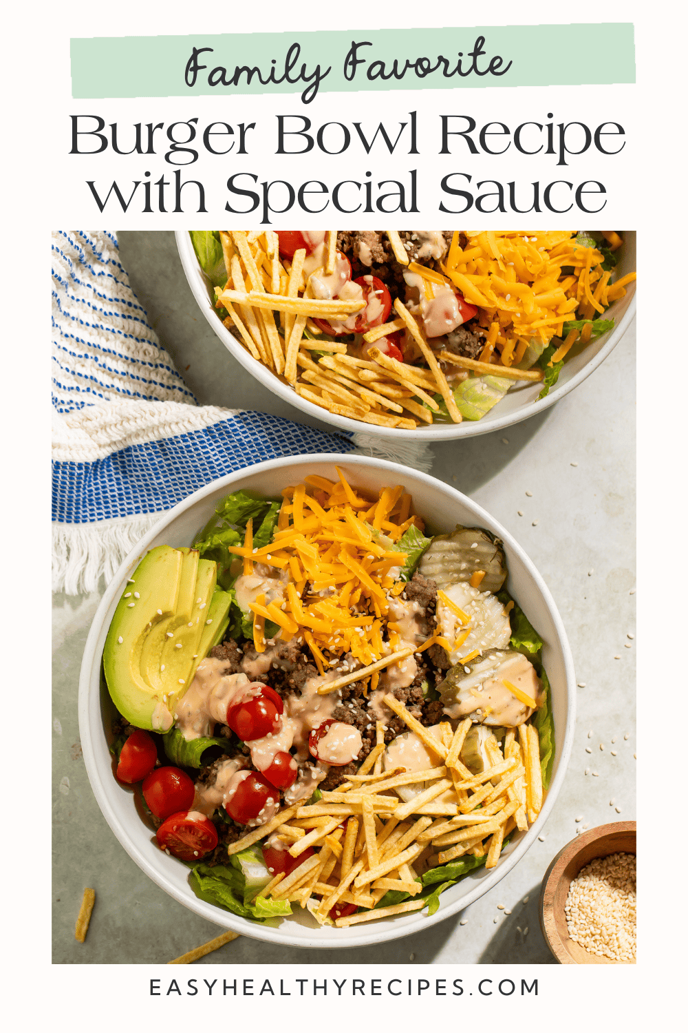Two burger bowls overhead with romaine, beef, cherry tomatoes, avocado, cheddar, and potato sticks