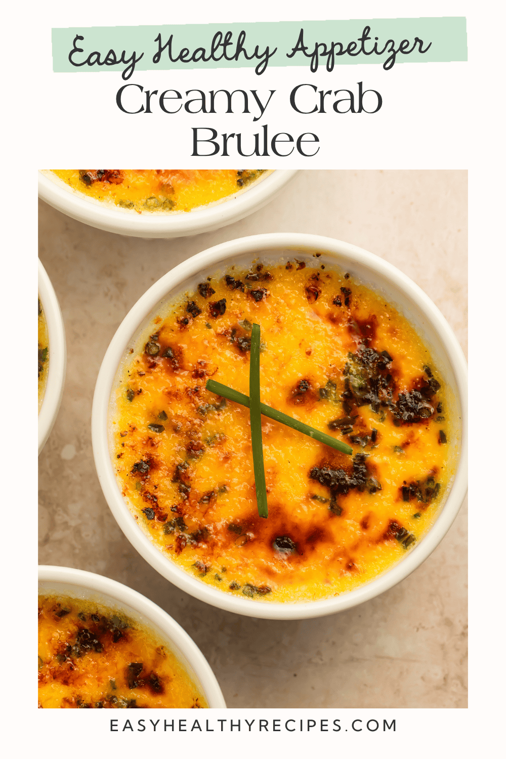Three white ramekins of crab brûlée with golden caramelized crusts arranged on a beige surface