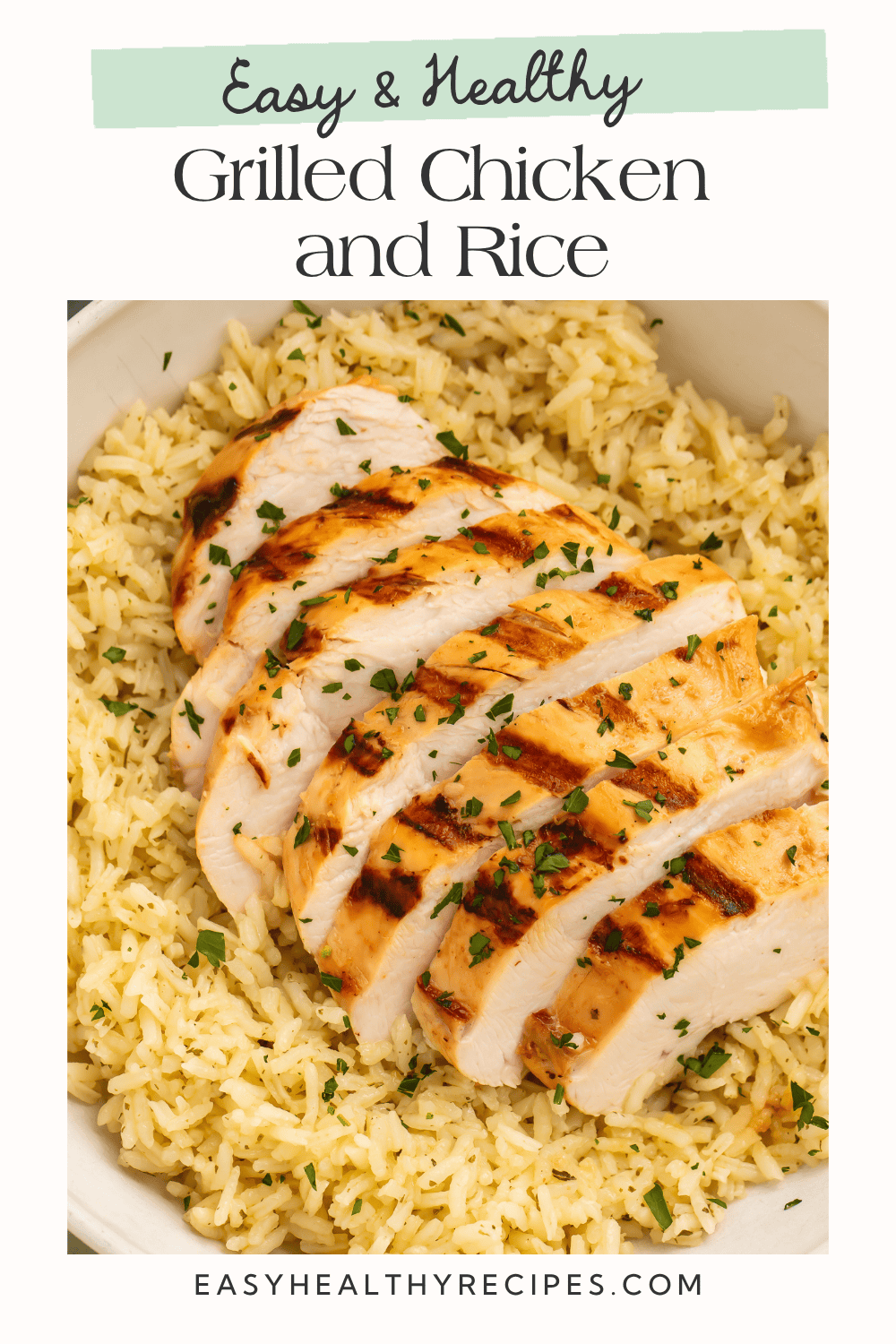 Sliced grilled chicken breast with grill marks served over seasoned rice in a white bowl