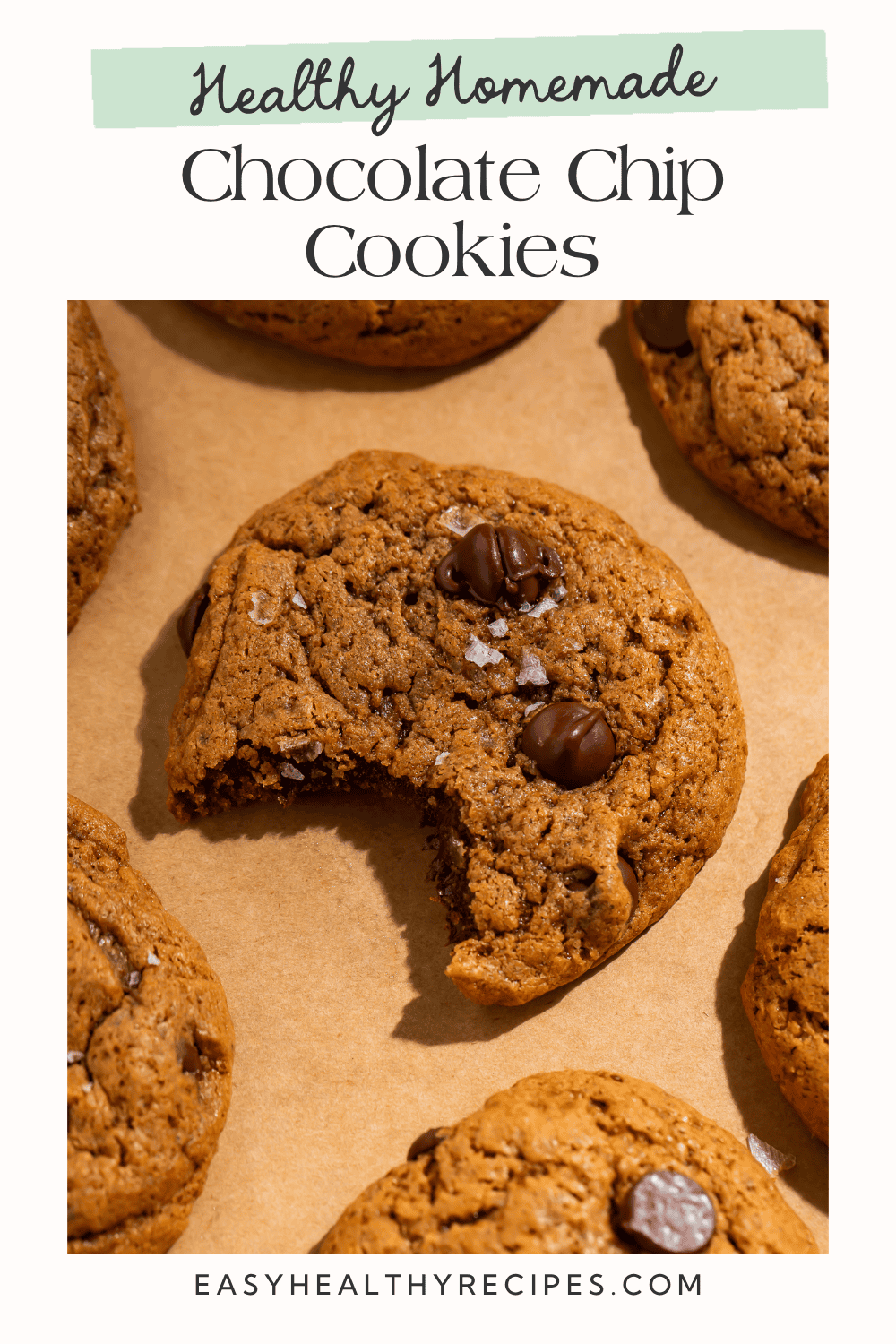 Healthy homemade chocolate chip cookies Pinterest pin with bitten cookie, chocolate chips, and flaky sea salt