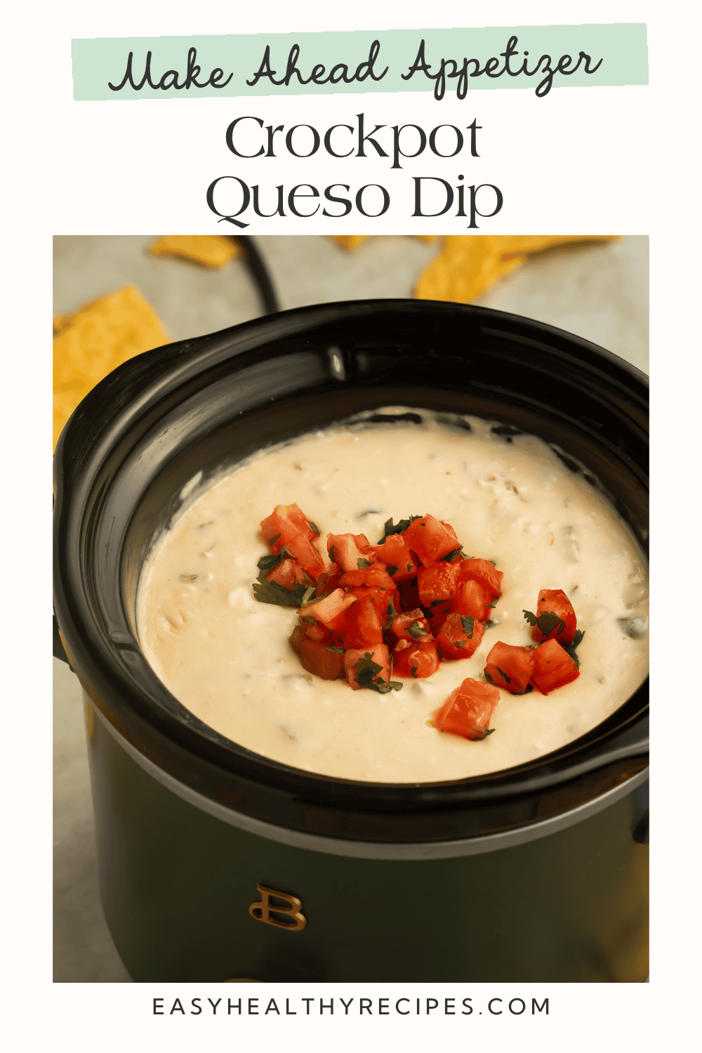 Crockpot queso dip with diced tomatoes and fresh herbs in a dark slow cooker insert