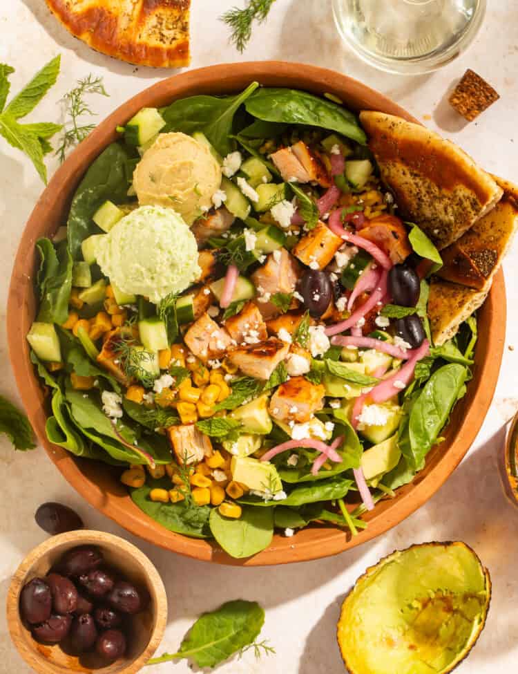 Harissa avocado bowl with chicken, hummus, Crazy Feta, and pita wedges