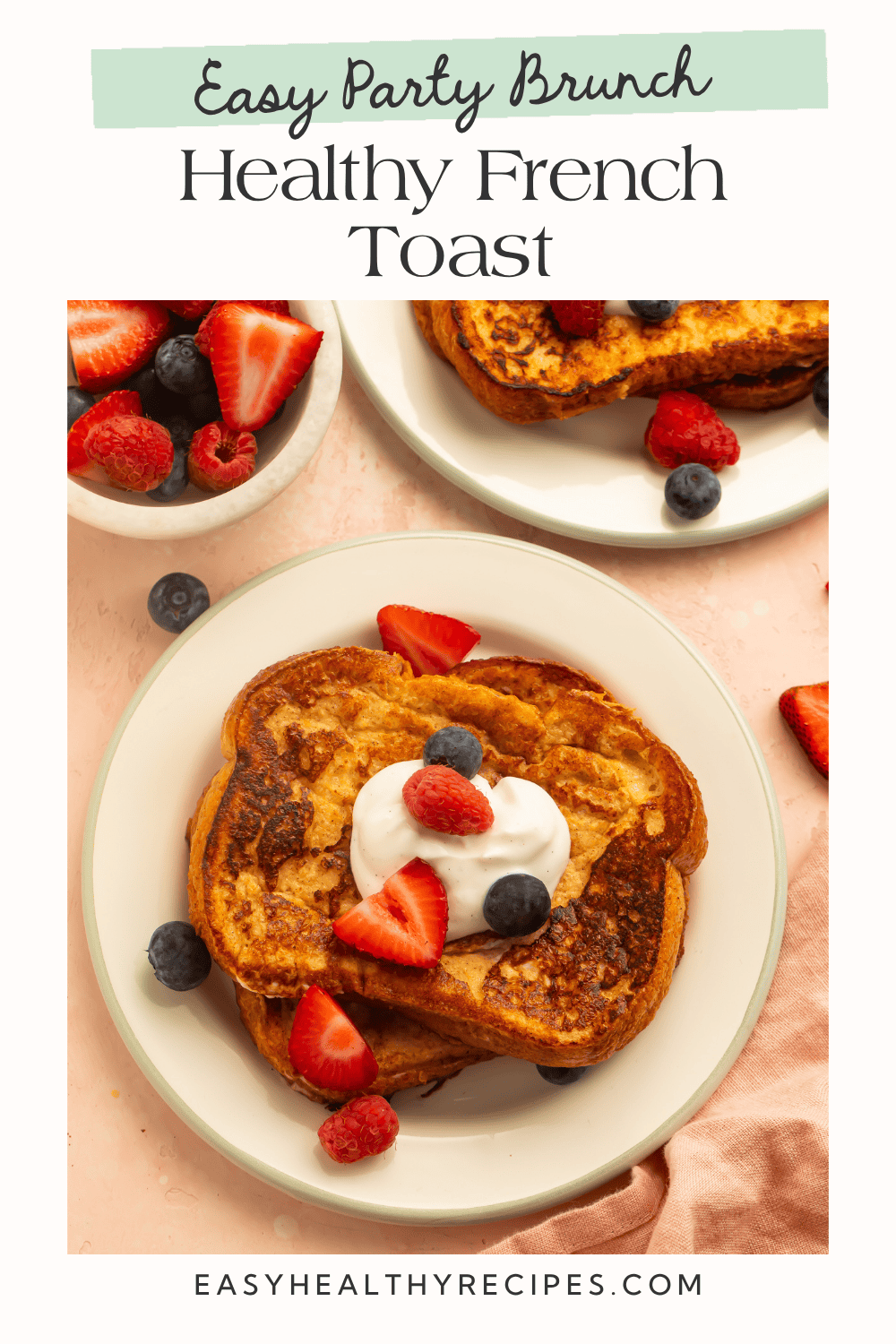 Overhead view of healthy French toast on a cream plate topped with Greek yogurt dollop and mixed berries