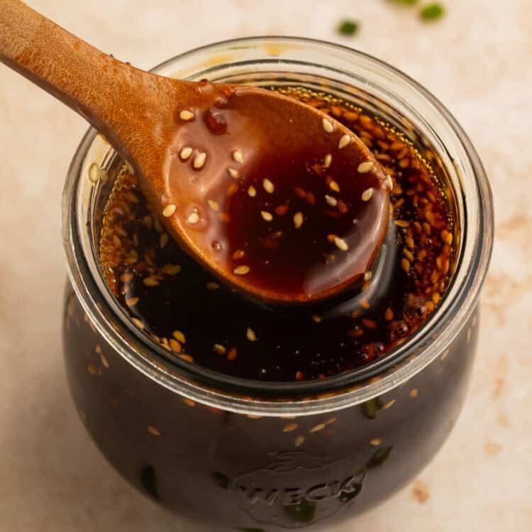 Spoonful of homemade teriyaki sauce over a jar of sauce