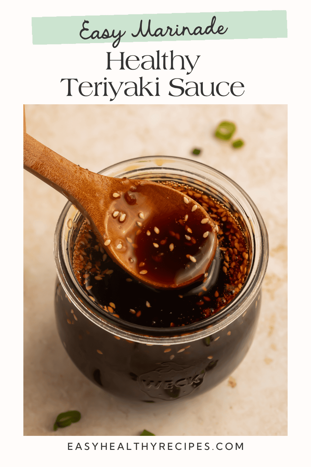 Spoonful of homemade teriyaki sauce over a jar of glossy teriyaki sauce