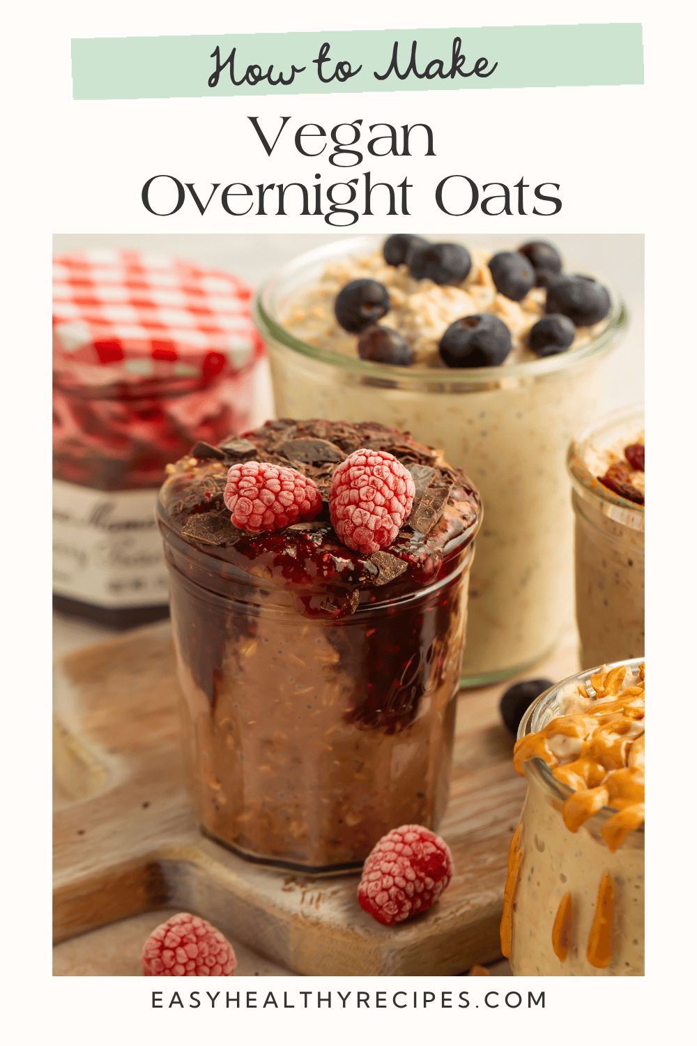 Close-up of chocolate vegan overnight oats topped with frozen raspberries and chocolate shavings in a glass jar