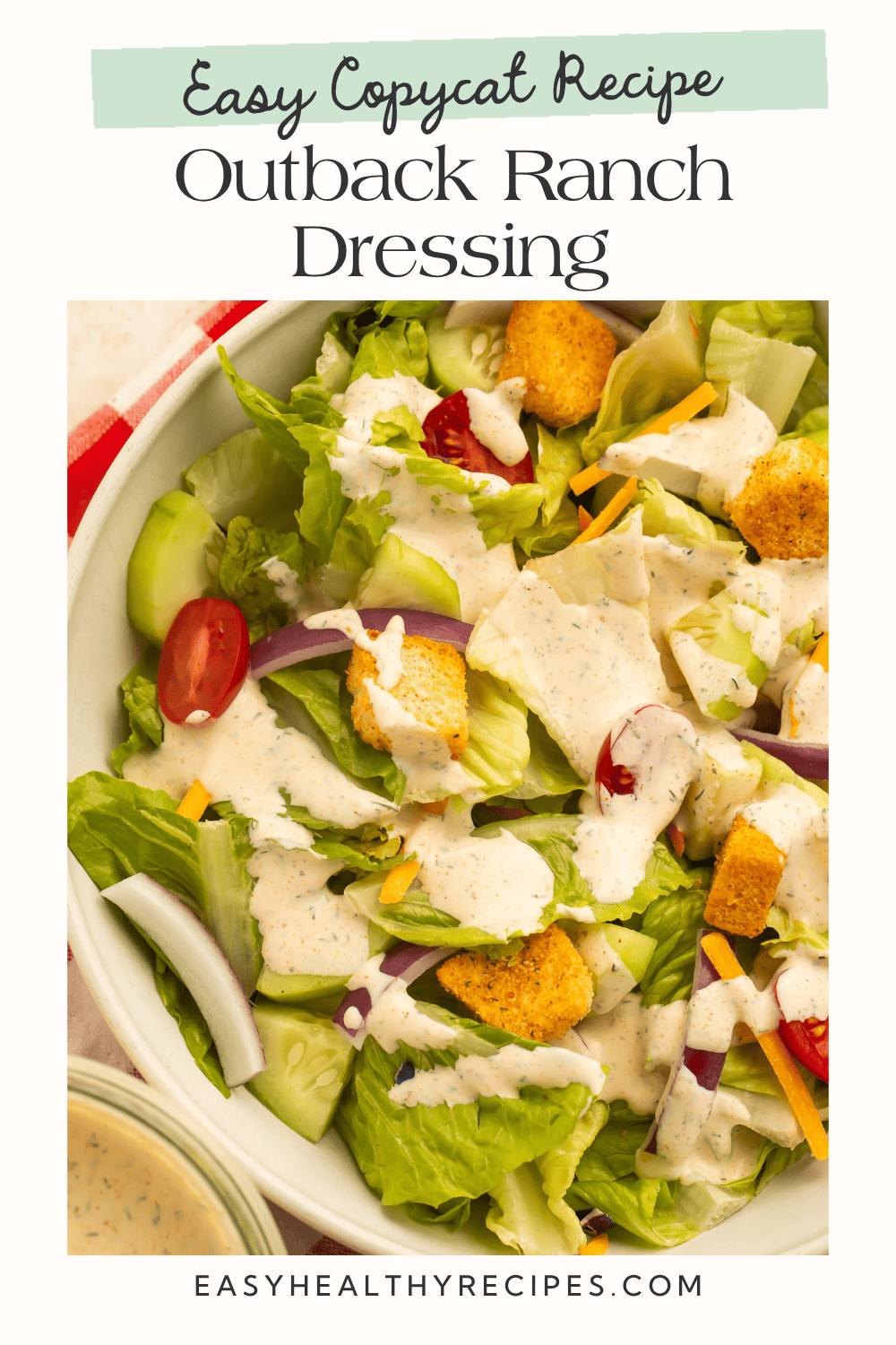 Creamy Outback ranch dressing drizzled over a garden salad with croutons and cherry tomatoes