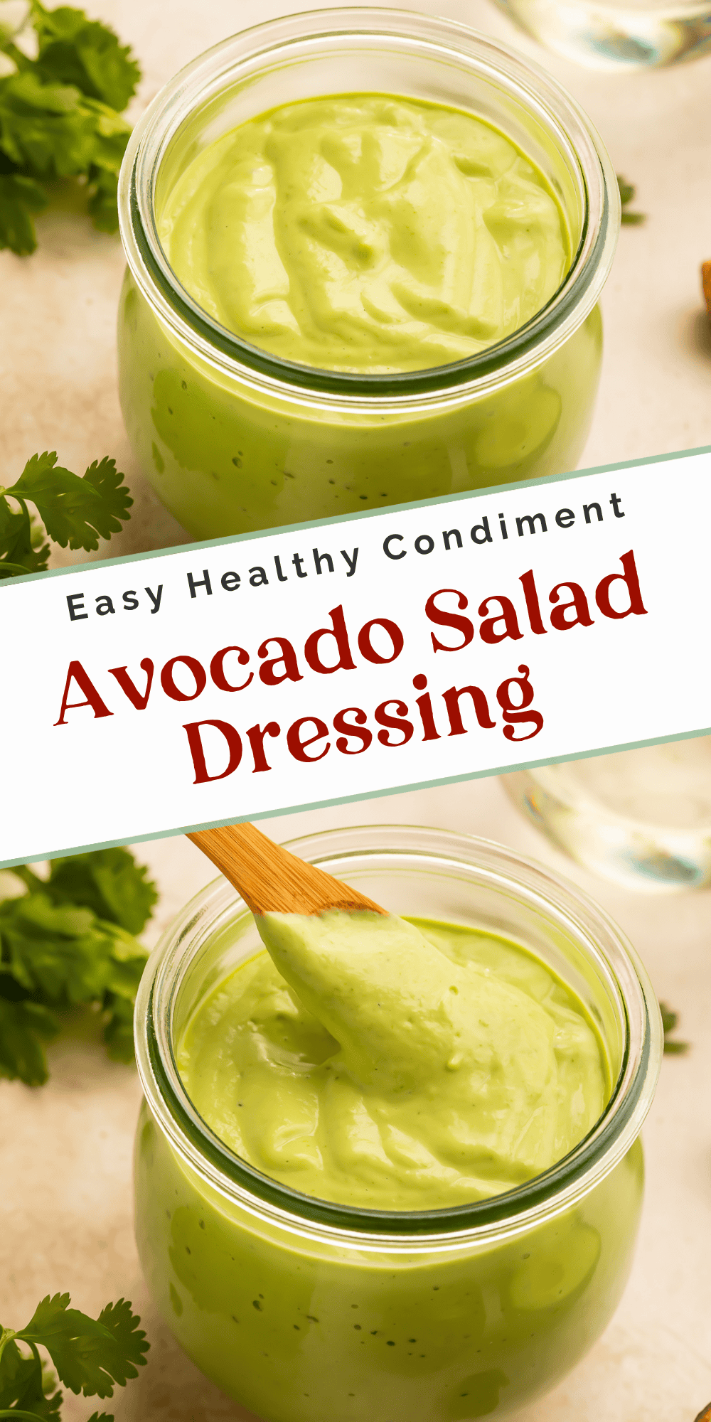 Glass jar filled with creamy avocado salad dressing beside fresh cilantro and avocado, with a wooden spoon coated in dressing.