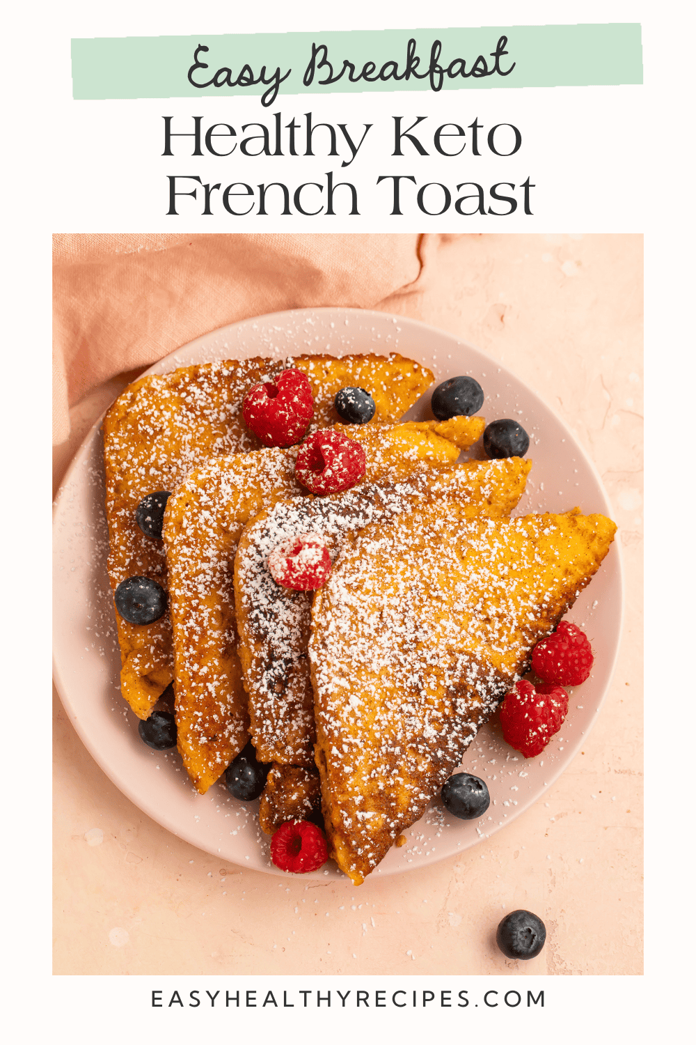 Healthy keto French toast topped with fresh raspberries, blueberries, and powdered sweetener for an easy low-carb breakfast.