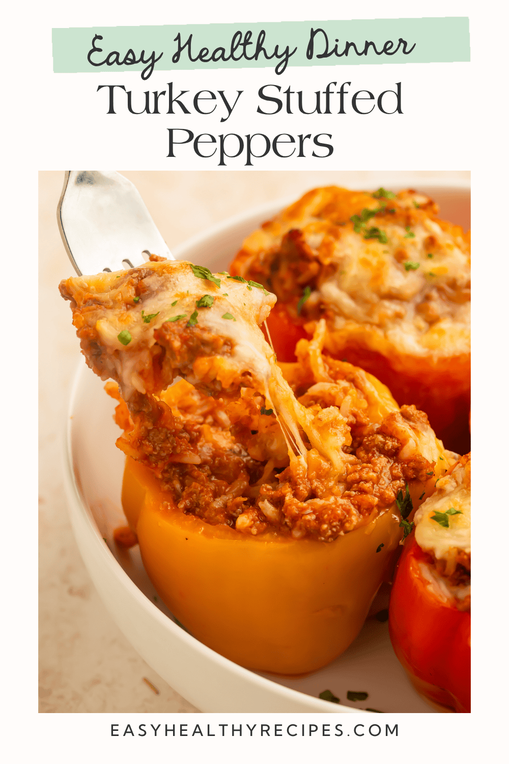 Pinterest graphic for healthy turkey stuffed peppers featuring a fork lifting a cheesy bite from a stuffed bell pepper with melted cheese and seasoned turkey filling