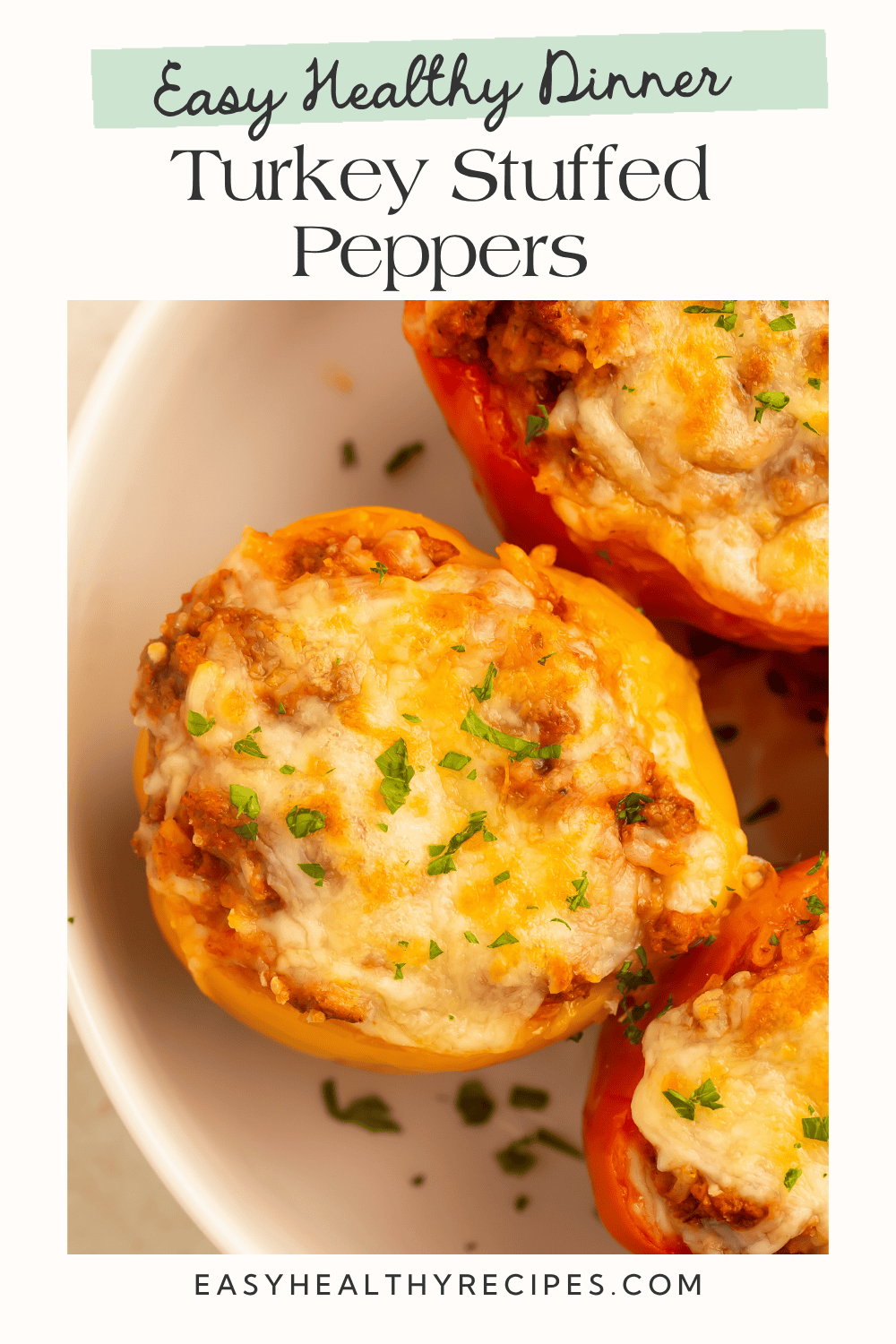 Pinterest graphic showing three baked turkey stuffed peppers topped with bubbly melted cheese and fresh parsley
