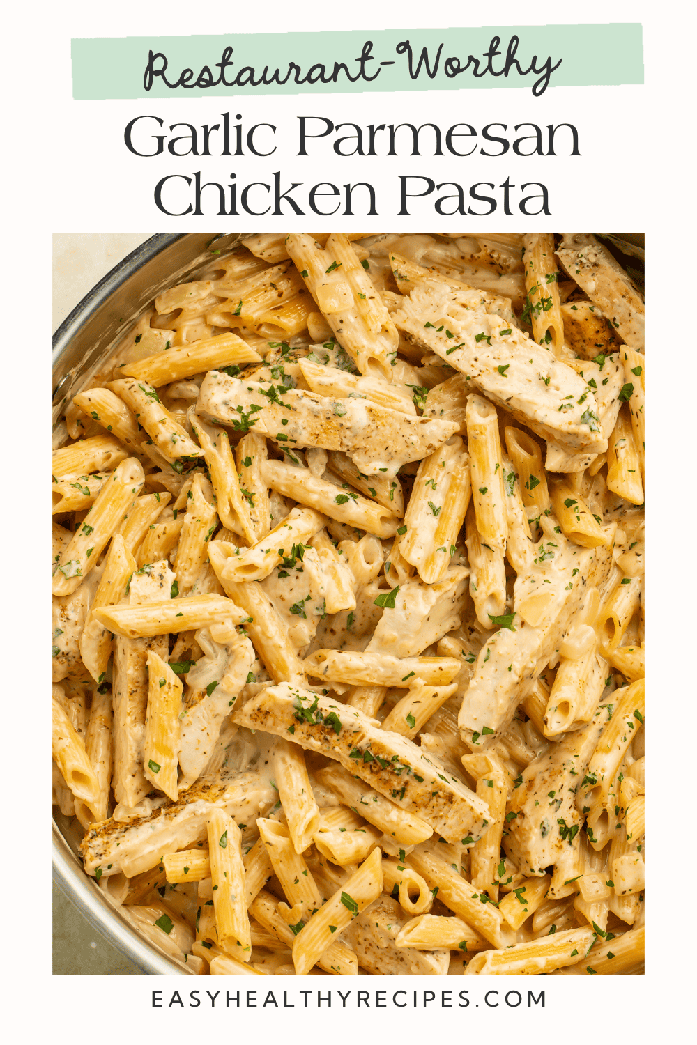 Garlic parmesan chicken pasta with golden chicken strips, penne, creamy parmesan sauce, and fresh parsley.