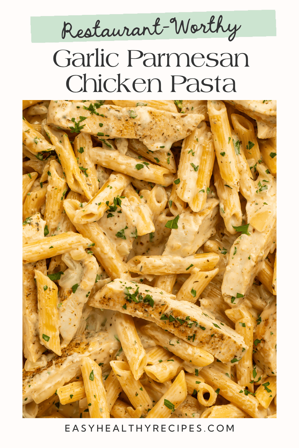 Restaurant-worthy garlic parmesan chicken pasta with seasoned chicken, creamy penne, and chopped parsley.