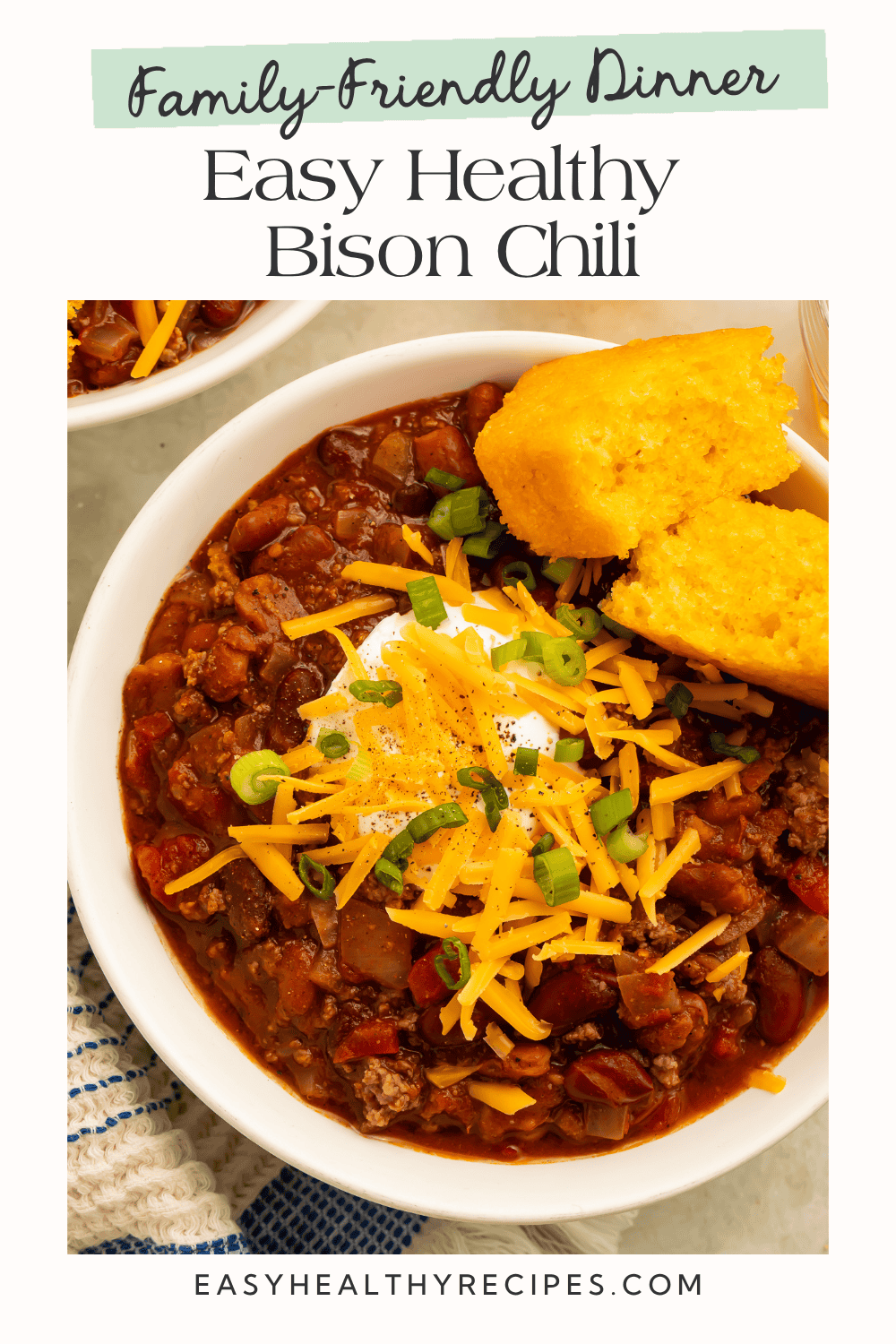 Family-friendly dinner graphic featuring bison chili with beans, cheddar, sour cream, green onions, and cornbread.
