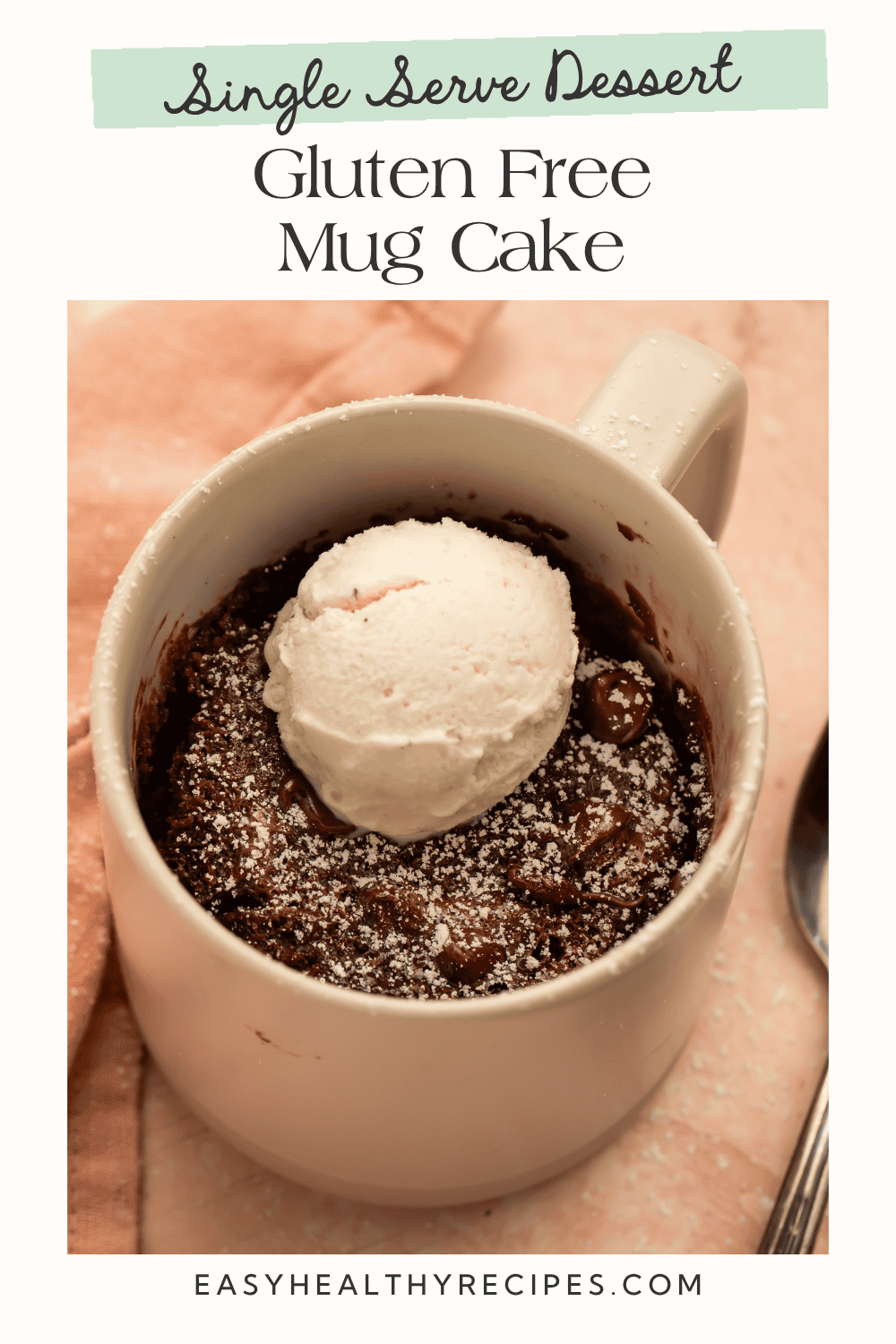 Gluten-free chocolate mug cake topped with vanilla ice cream, powdered sugar, and chocolate chips.