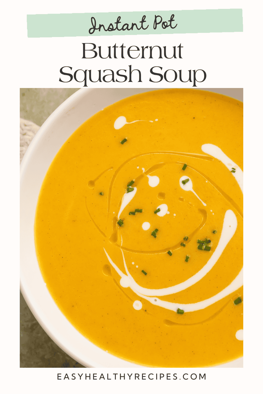 Creamy golden butternut squash soup with a white swirl and chives, titled “Instant Pot Butternut Squash Soup.”