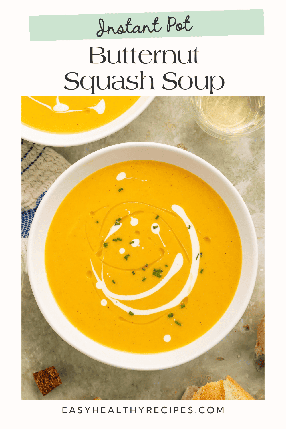 Golden squash soup topped with a creamy swirl and chopped chives, with the title “Instant Pot Butternut Squash Soup.”