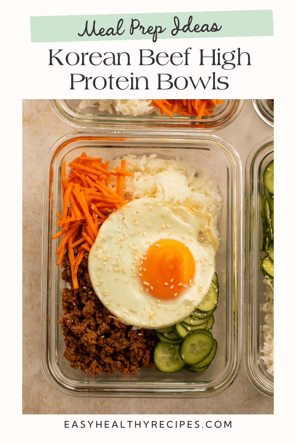 Korean beef meal prep bowl with rice, carrots, cucumbers, and a fried egg.