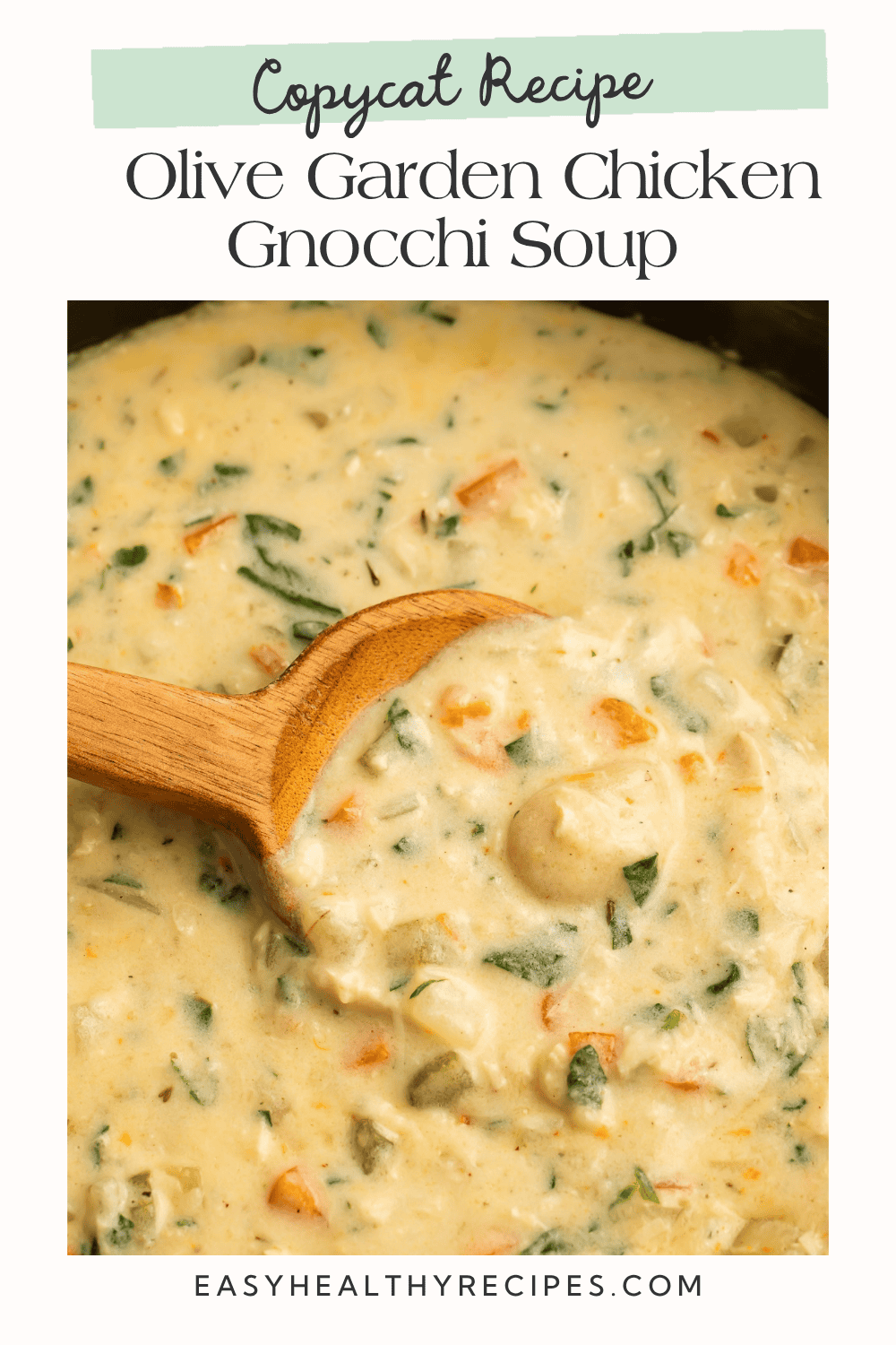 Spoonful of creamy Olive Garden copycat soup with potato gnocchi, chicken, and spinach.