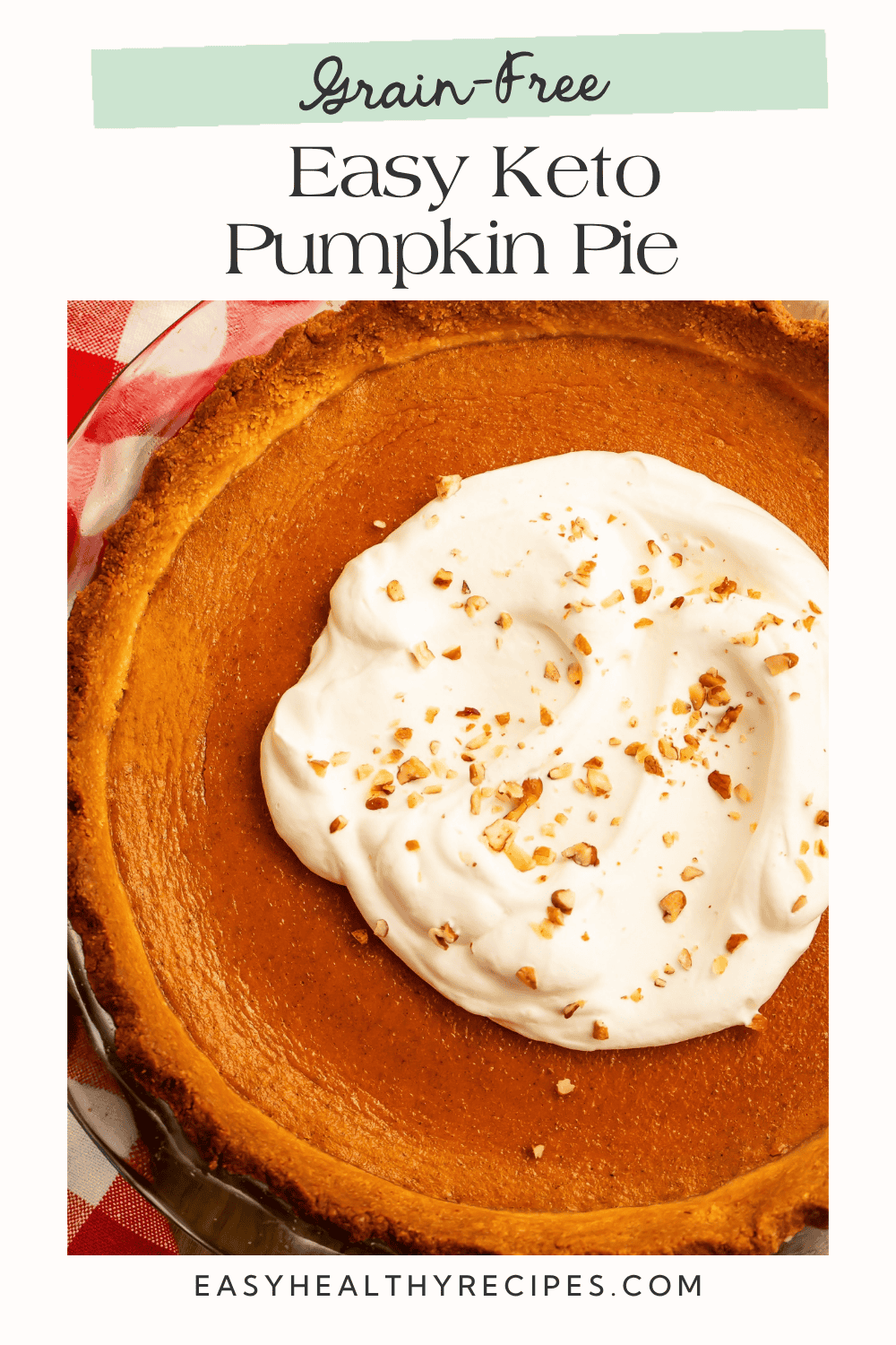 Pumpkin pie in a glass dish with whipped cream and chopped nuts in the center. Text reads “Grain-Free Easy Keto Pumpkin Pie.”